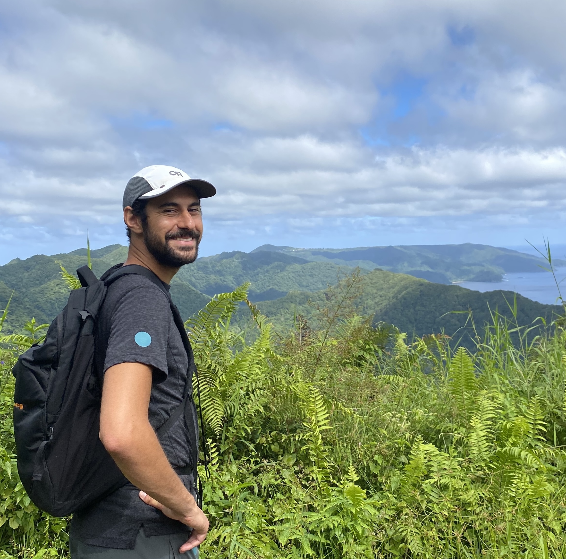 A photo of me on a hike with the mountains of American Samoa in the background